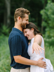 Couple celebrating their proposal at Nichols Arboretum in Ann Arbor, MI after she said yes Intimate proposal moment photographed at Nichols Arboretum, Ann Arbor with natural light