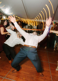Outdoor Michigan backyard wedding ceremony showing natural surroundings and a timeless white and greenery aesthetic