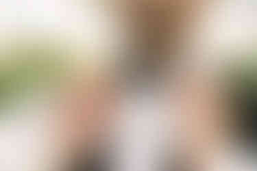 Backyard wedding ceremony in Michigan featuring greenery, white flowers, and elegant draping for an outdoor summer wedding