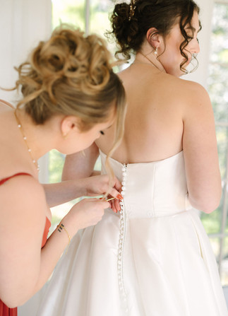 Bride getting ready in the Pine Knob Mansion bridal suite during an early fall wedding