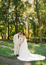Wedding couple posing in Pine Knob Mansion gardens surrounded by early fall colors