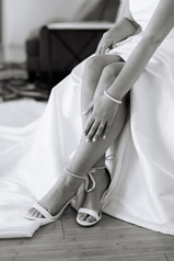 Bride getting ready in the Pine Knob Mansion bridal suite during an early fall wedding