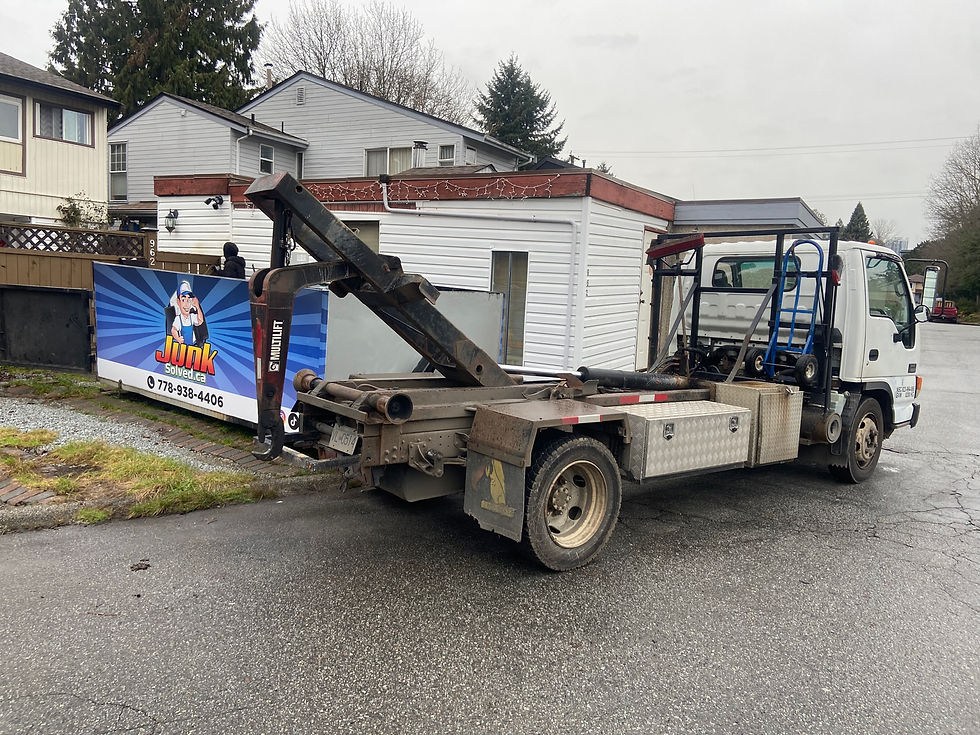 Eye-level view of a junk removal truck parked outside a residential home