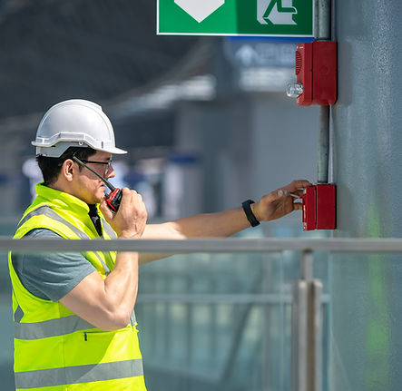 engineer-wearing-safety-unifrom-and-helmet-under-checking-fire-alarm-emergency-system-in-i
