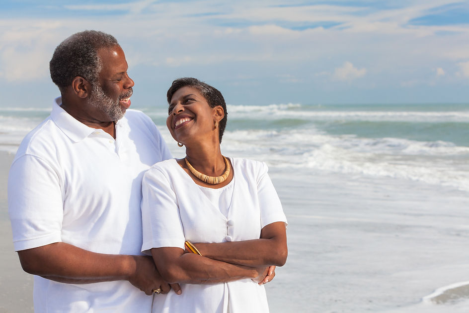 Happy Couple Walking Along The Beach