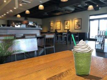 matcha green tea frappacino sitting on a table