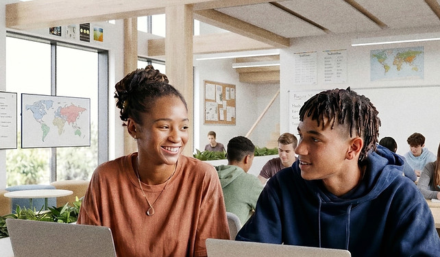 Two students using the Arch curriculum in a brightly-lit classroom