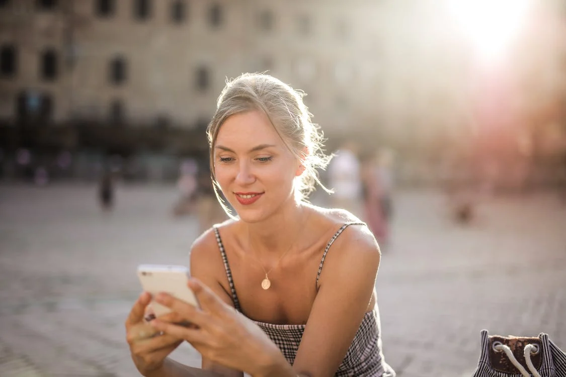 Smiling woman looking at her phone