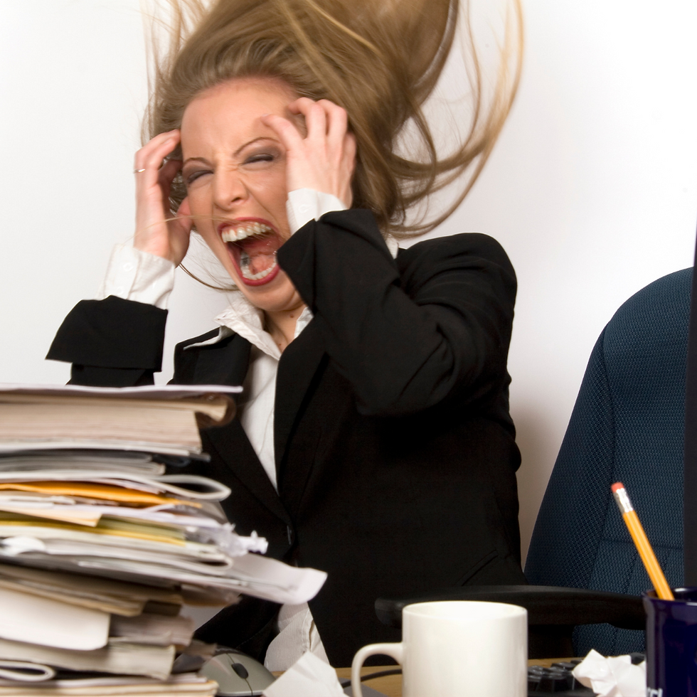 A female manager dressed in a business suit. She is very stressed out with a pile of paperwork in front of her. Her face shows a lot of anxiety and overwhelm, she is facing a storm at the office