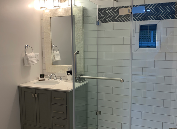 newly remodeled bathroom with new vanity and glass enclosed shower