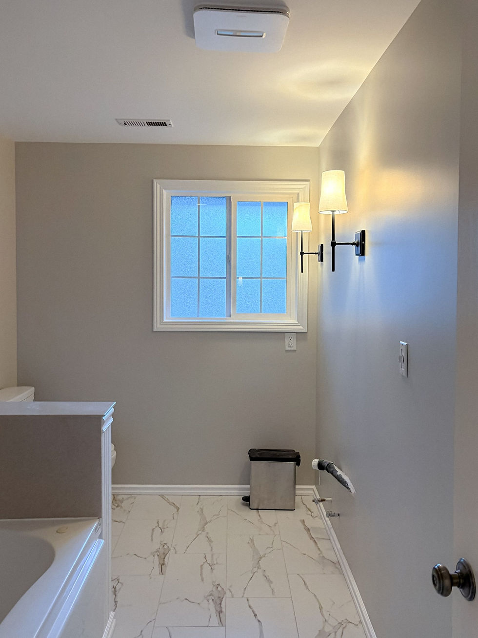 Bathroom with freshly painted gray walls, white trim and tile floor