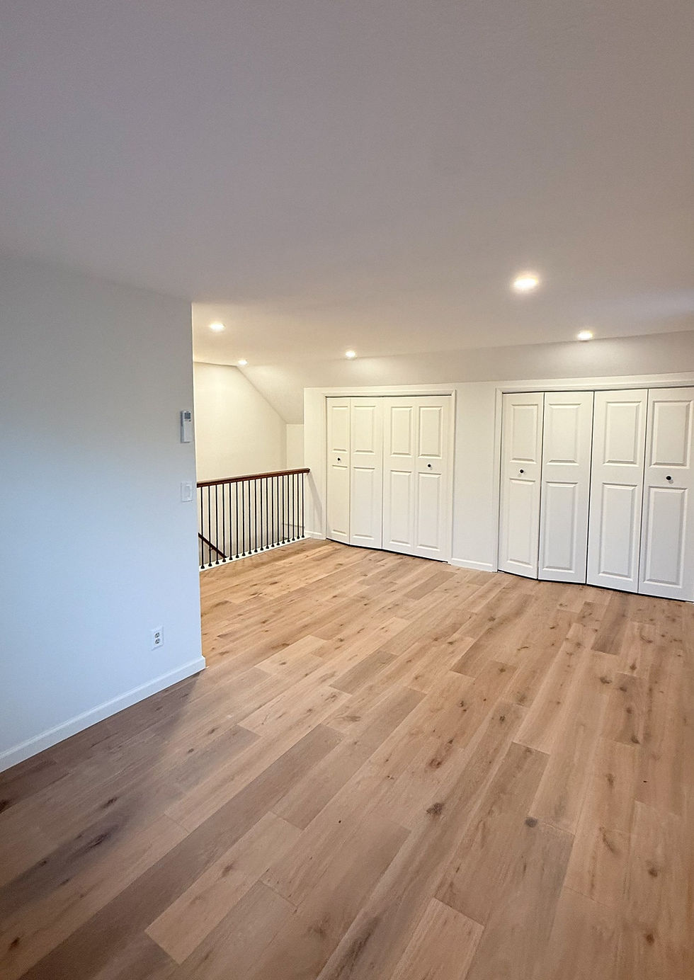 Freshly painted room with smooth white walls, painted closet doors and white trim