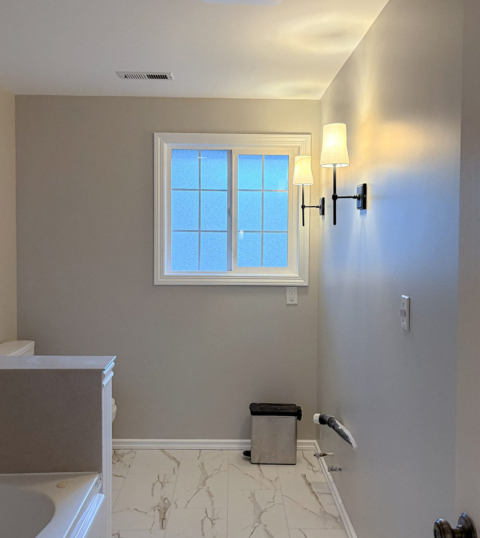 Level 5 drywall finish: smooth bathroom walls with sconce lighting after skim coat, Vancouver WA