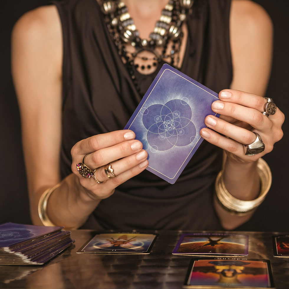 Erin Rose Gallagher holds a tarot card during a Trine Aligned Tarot Card Reading