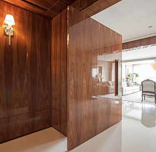 High-gloss French Polishing finish on luxury dark wood architectural paneling, showing deep reflective grain.