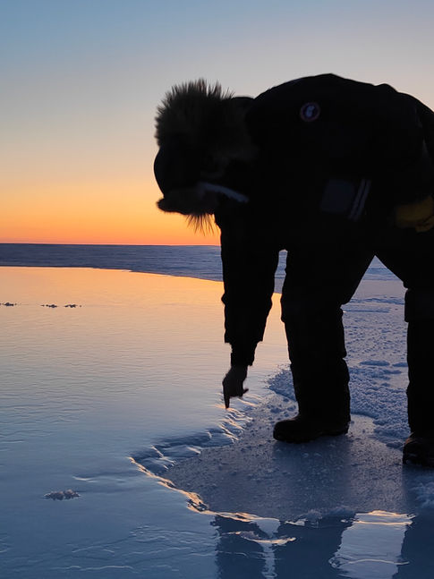 Brandon Langan touches edge of pond created by Real Ice. 