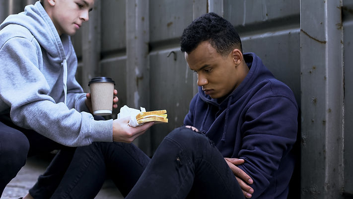 Caring volunteer boy brings dinner to homeless teenager, kind heart, charity.jpg