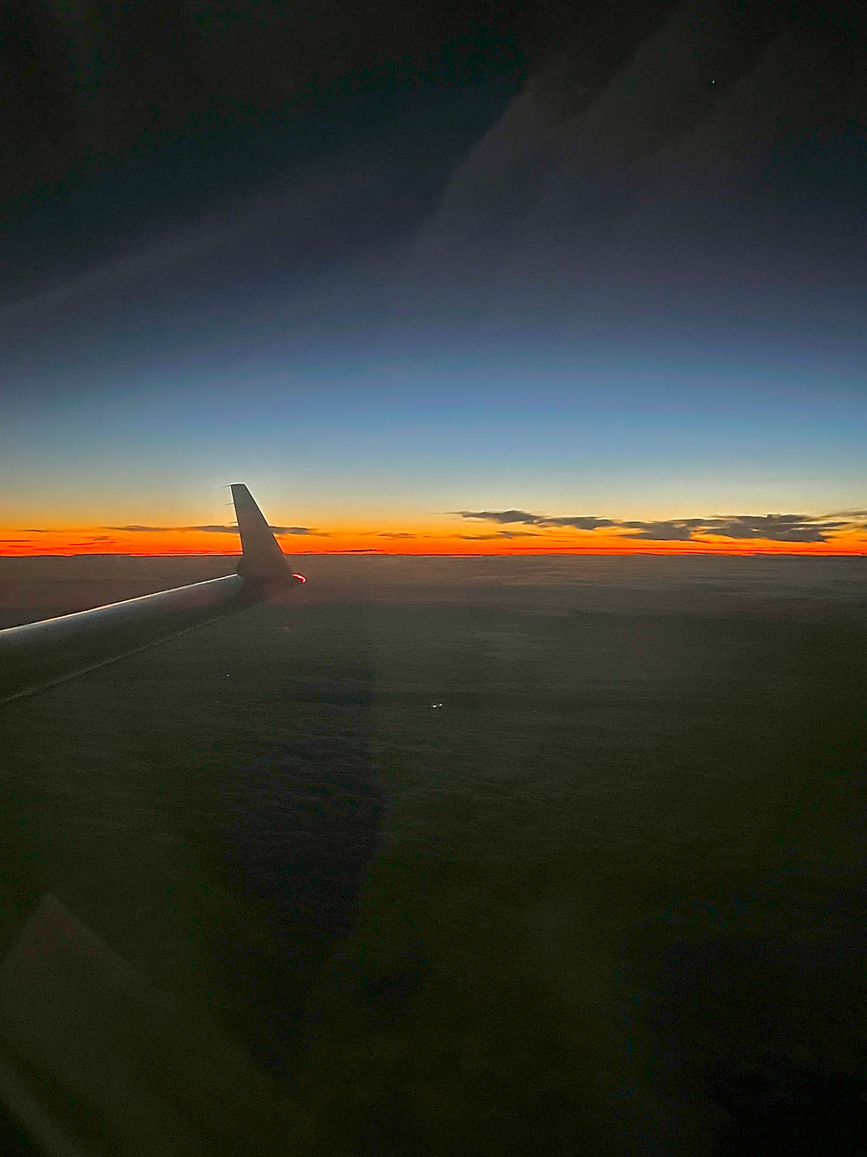 Sunrise view from airplane window on a long-haul flight to beat jet lag