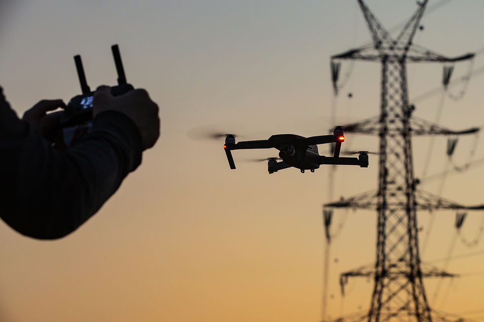 A concept of a man flying a drone collecting a data remotely from a power tower station or