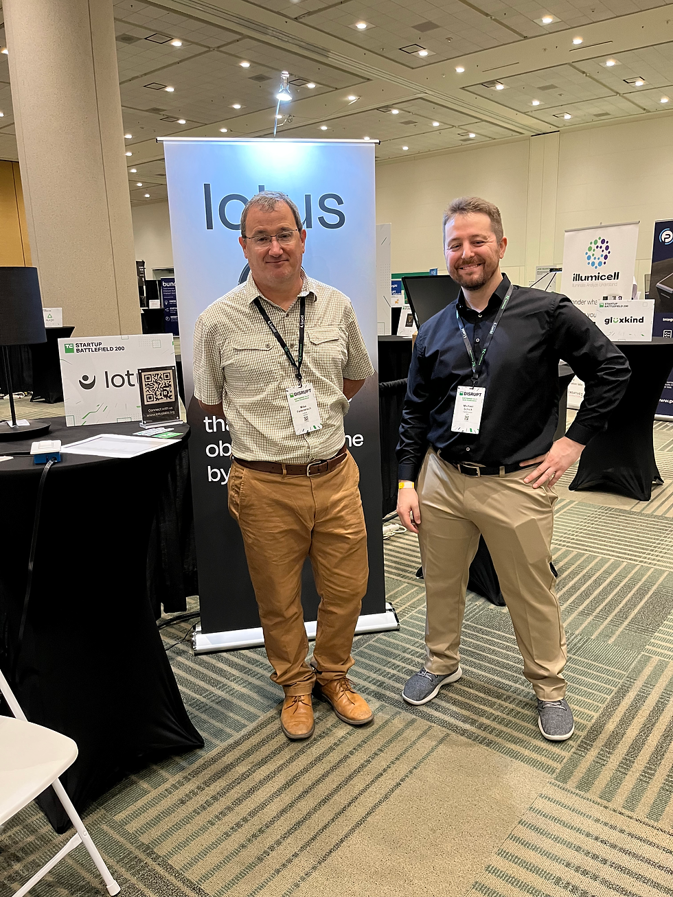 Two men standing in front of the Lotus exhibitor booth