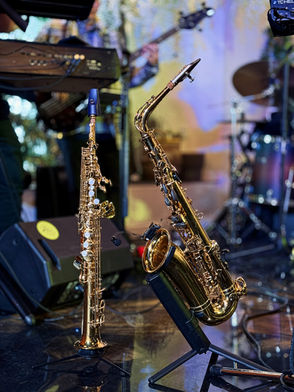 Saxophone and flute on stands at a music performance