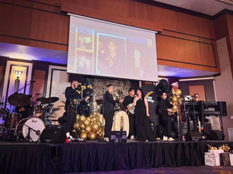 The AC Project performing on stage at a grand 50th birthday celebration.