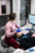 Orthodontist performing a digital dental scan with the iTero scanner for Invisalign treatment planning