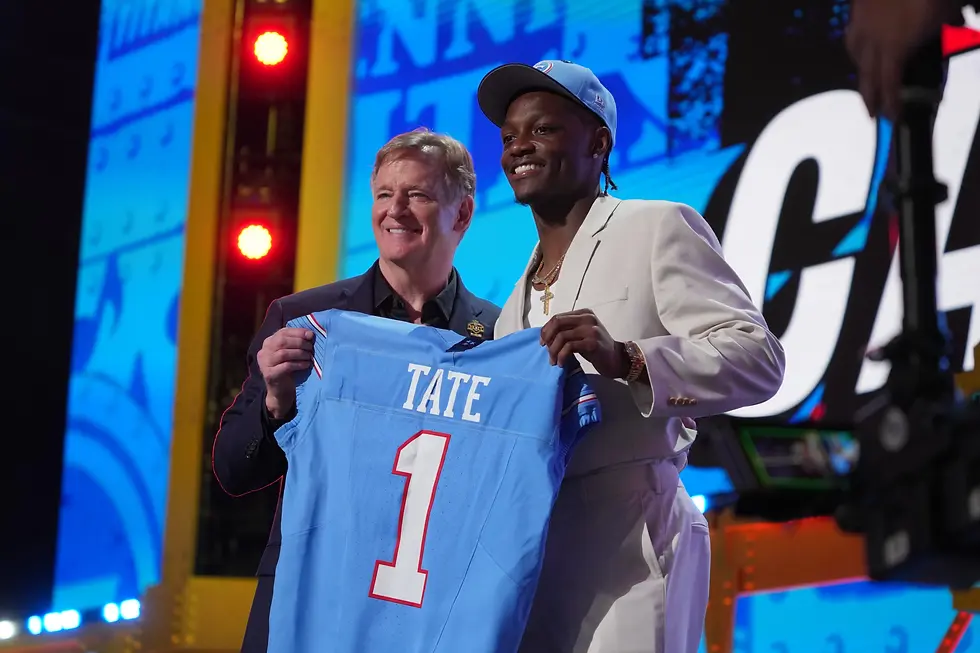 Carnell Tate holds his new jersey up with NFL commissioner Roger Goodell. (Photo: Gene J. Puskar / AP)