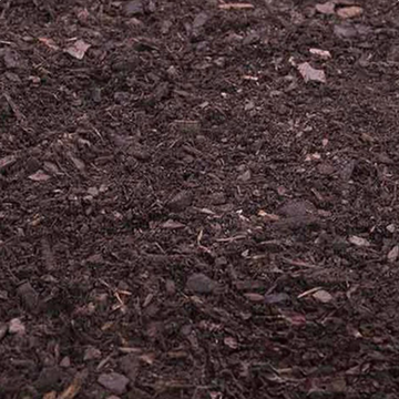 Close-up of Fine Grind Nature’s Blend mulch featuring a dark, rich, soil-like texture and finely shredded organic fibers for a premium landscape bed finish.