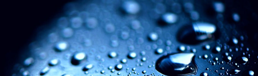 Gotas de lluvia en una superfÃcie plana con un fondo oscuro. Expertos en tratamiento de sóldios