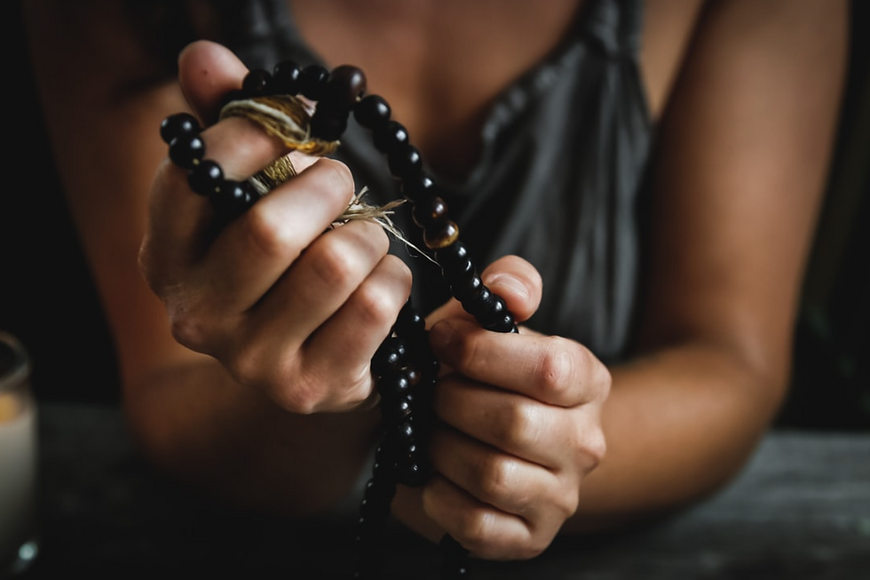 Hands holding a mala.