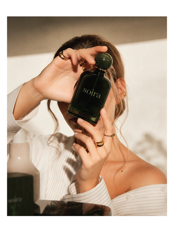 Model holding the Soira perfume bottle as part of a luxury fragrance branding and lifestyle campaign by Brandfinity.