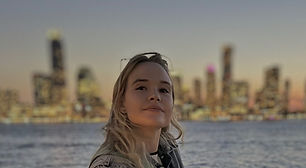 Catherine in front of a city skyline.