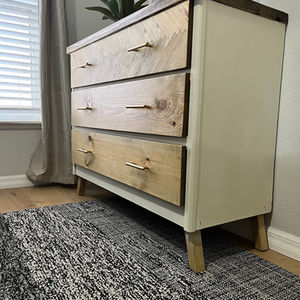 Upcycled wooden dresser with fresh paint and newly replaced wooden drawers