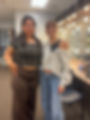 Two women posing in a backstage dressing room.