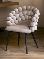 Beige upholstered chair with black legs. Modern design for elegant dining room.