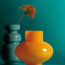 Two decorative jars, one turquoise and the other in yellow.