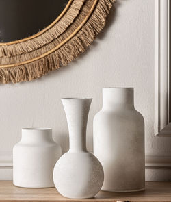 Three white matte jars in different shapes.