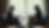 Eye-level view of a mediation session with two individuals discussing peacefully