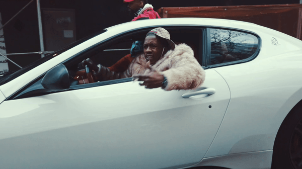 Rapper 2Milly driving in Zenith Exotic Rentals Maserati Granturismo