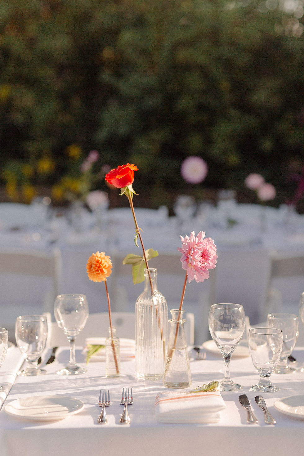 single stalk flowers in glass bottles wedding table decor