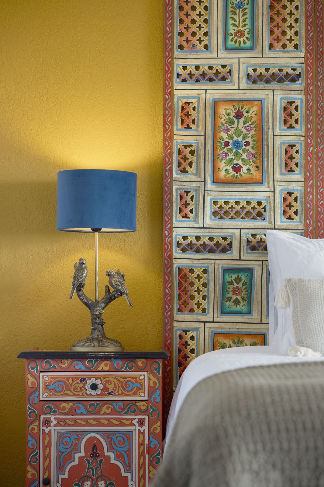 Pilea Suite: ochre wall with painted headboard