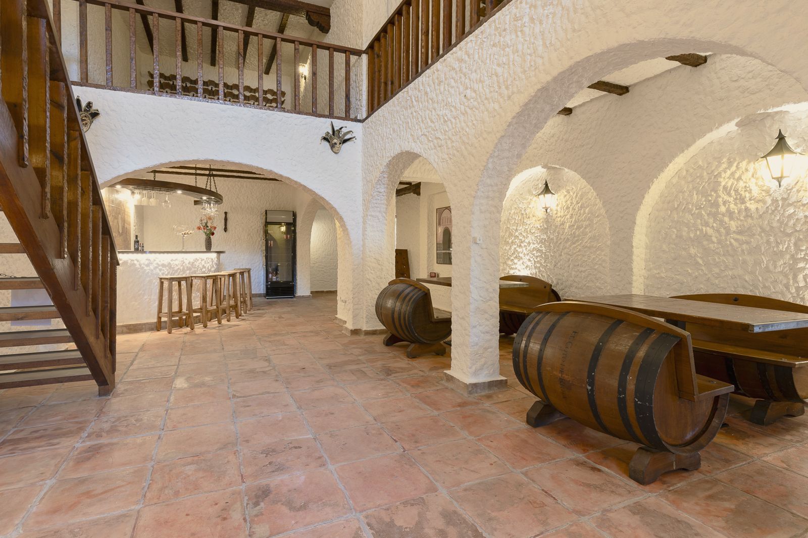 Wine cellar with barrels under white Andalusian arches