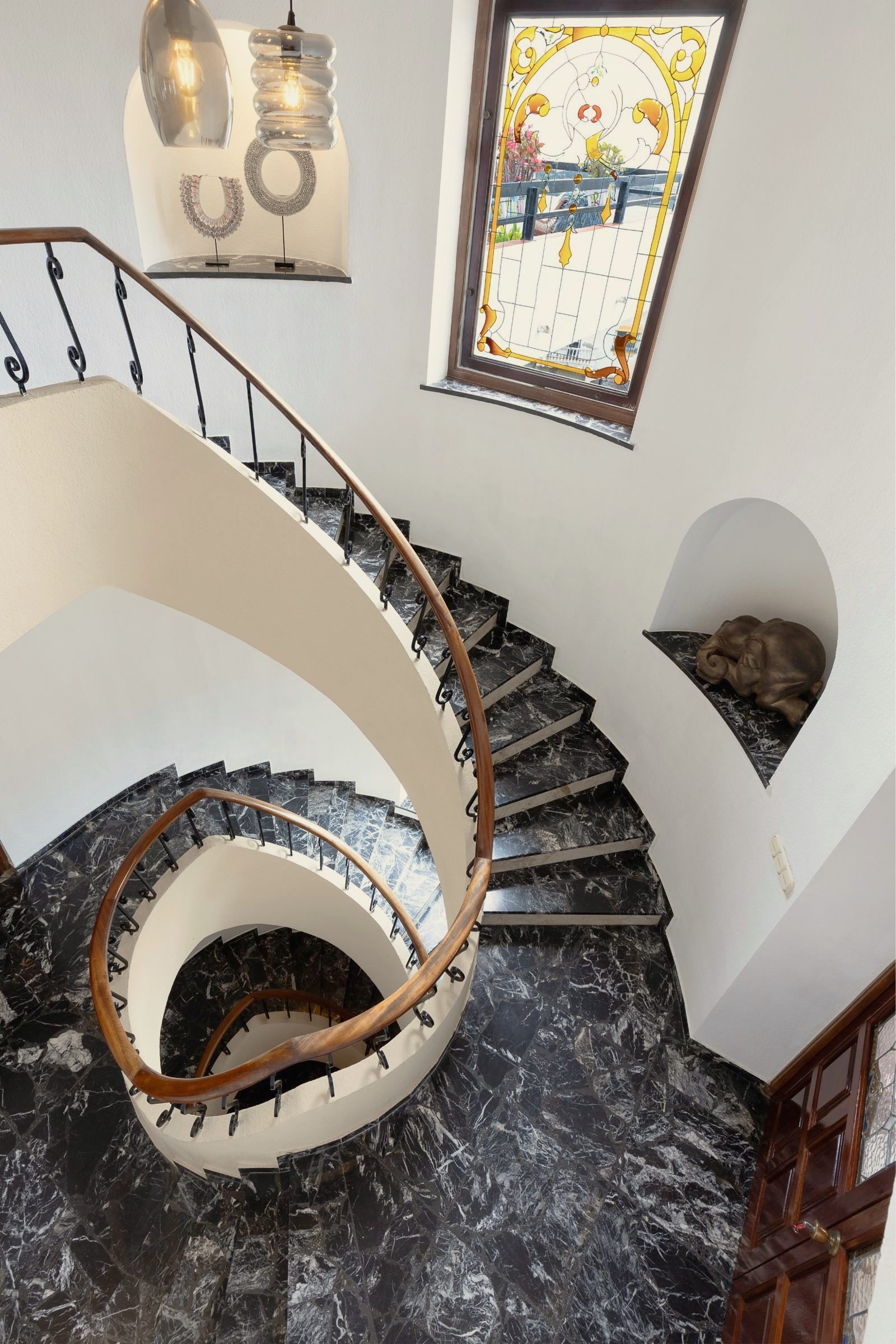 Spiral staircase with a stained-glass window