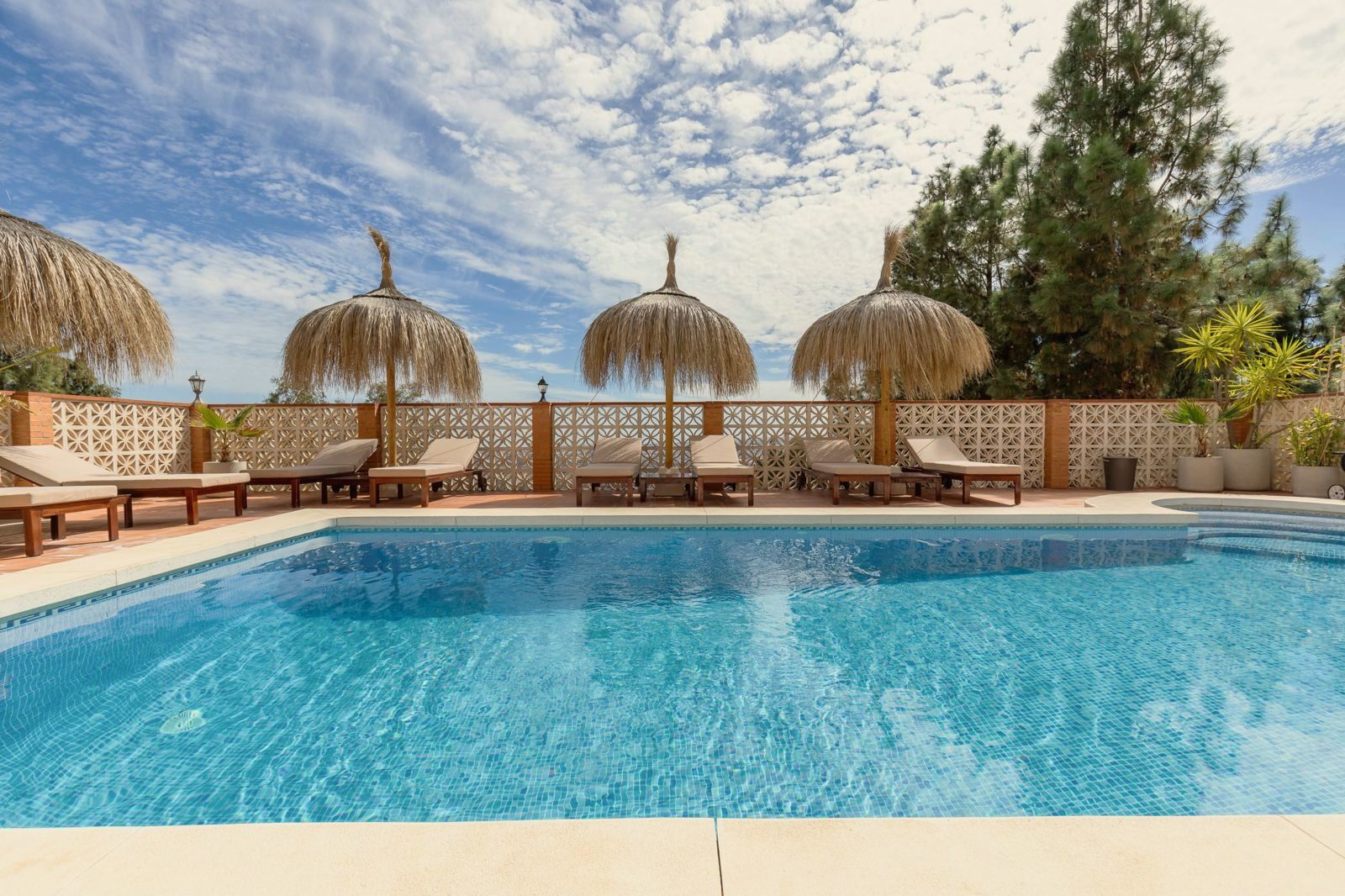 Pool and terrace under a summer sky