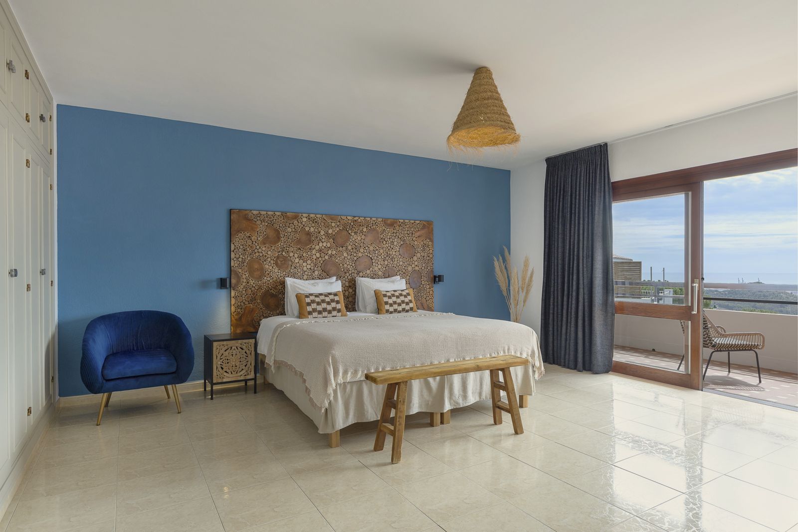 Yucca Suite: blue bedroom with velvet armchair