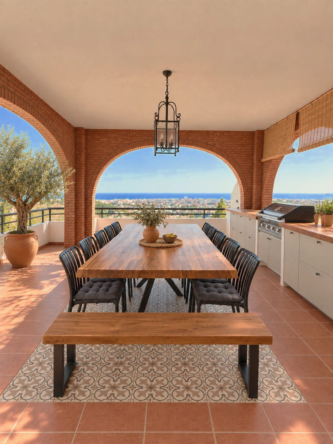 Covered terrace with a long dining table and arched view over the sea