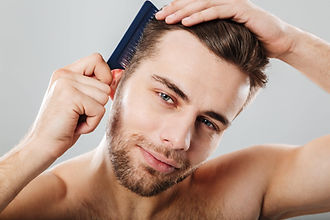 close-up-portrait-smiling-man-combing-his-hair-min-min.jpeg