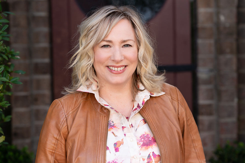headshot of woman in leather jacket, smiling and happy, downtown Southern Pines taken by Makana Photography, a southern pines and Aberdeen and pinehurst based headshot and branding photographer
