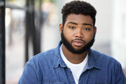 Man outdoor actor headshot sitting on steps